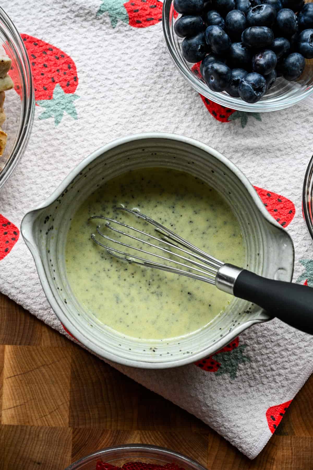 Overhead view of strawberry poppyseed salad after whisking it together.