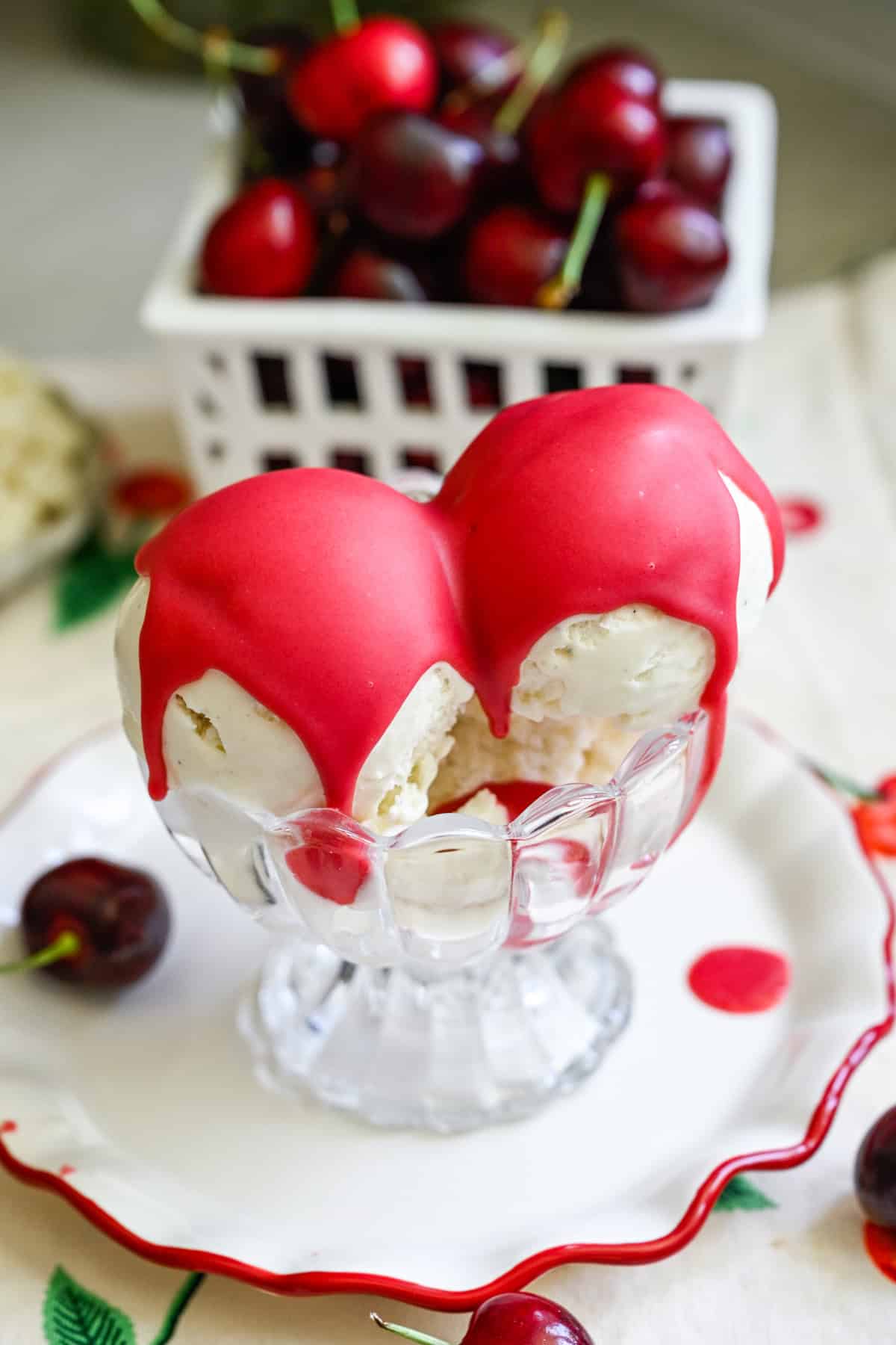 Cherry magic shell poured on top of two scoops of vanilla ice cream.