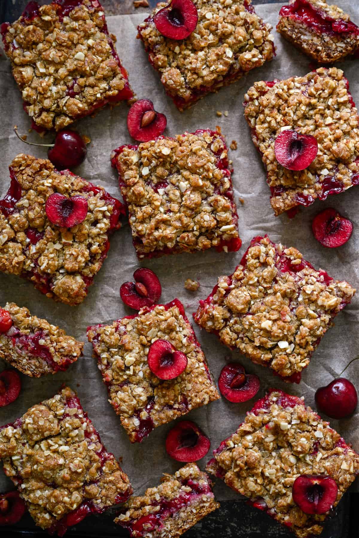 overhead view of cherry pie bars on parchment paper.