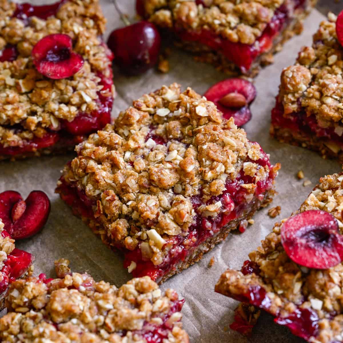 close up view of cherry pie bars on parchment paper.