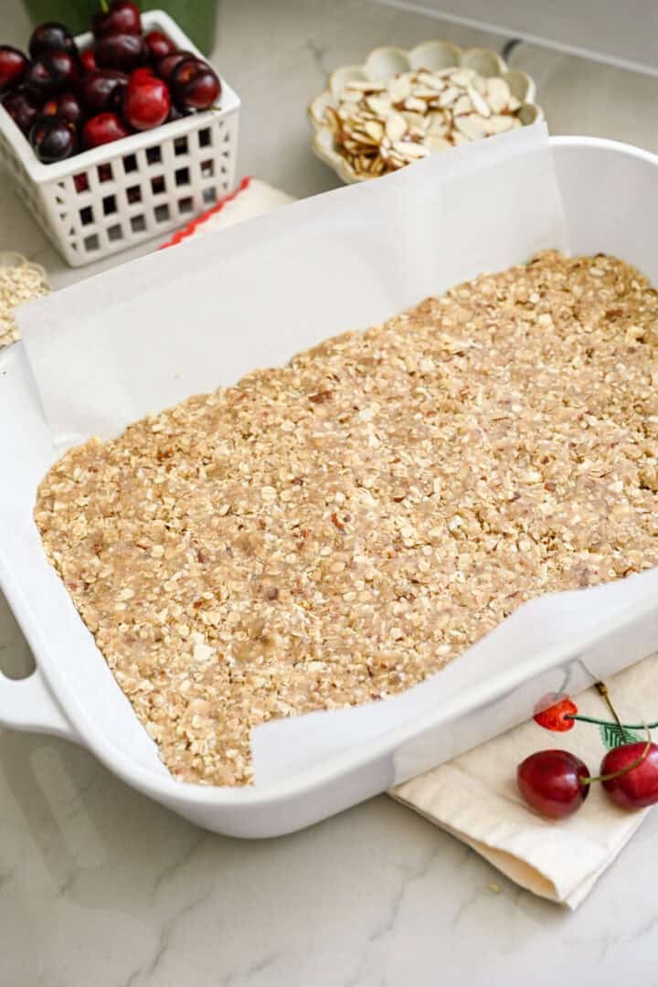 cherry pie bar crust pressed into a 9x13 baking dish.