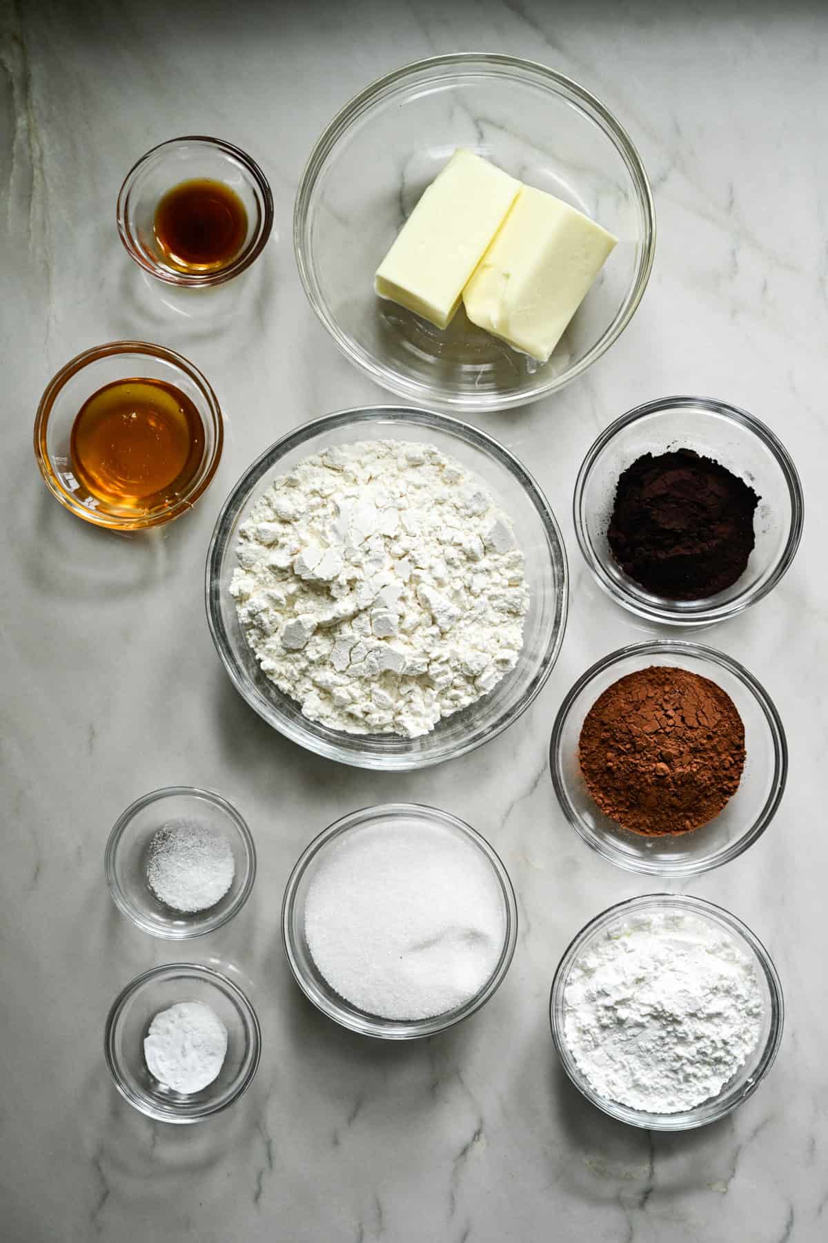 Overhead view of ingredients for homemade oreos in small bowls.