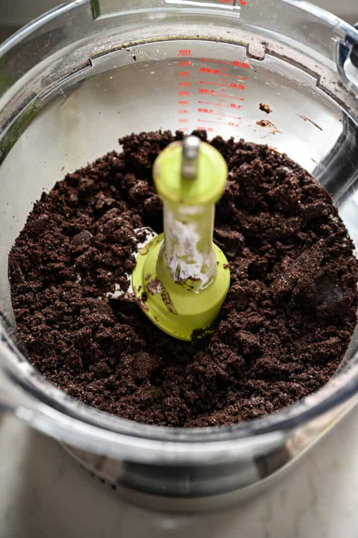 Oreo cookie dough in food processor after mixing.