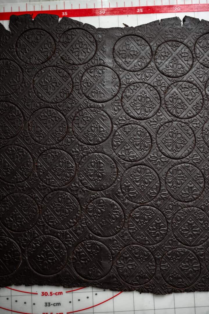 Oreo cookies cut into circles on large rectangle of dough.