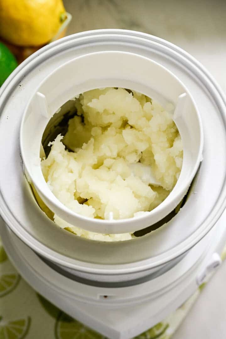 Lemon lime italian ice in an ice cream maker after churning.