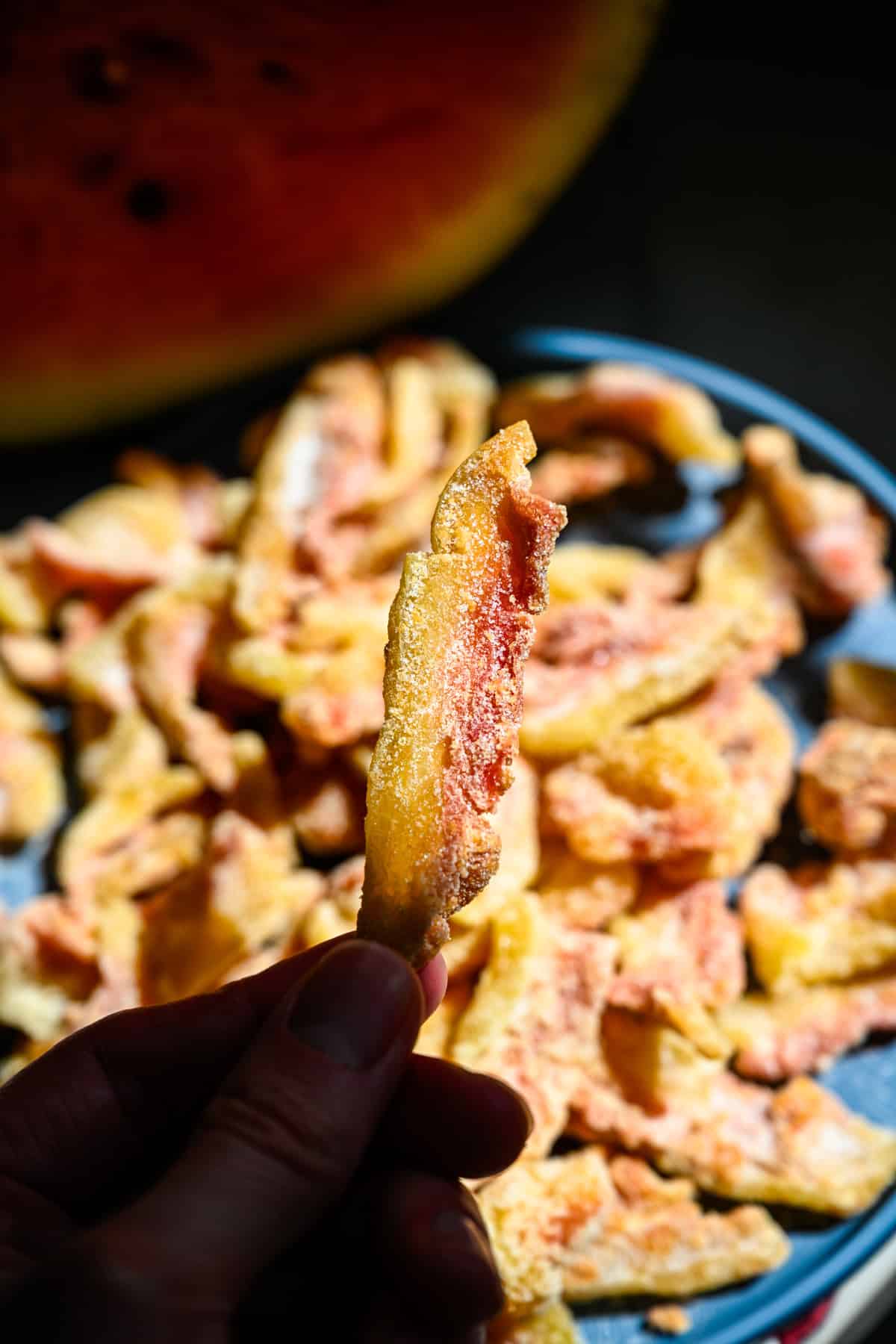 Watermelon rind candy on a blue plate.
