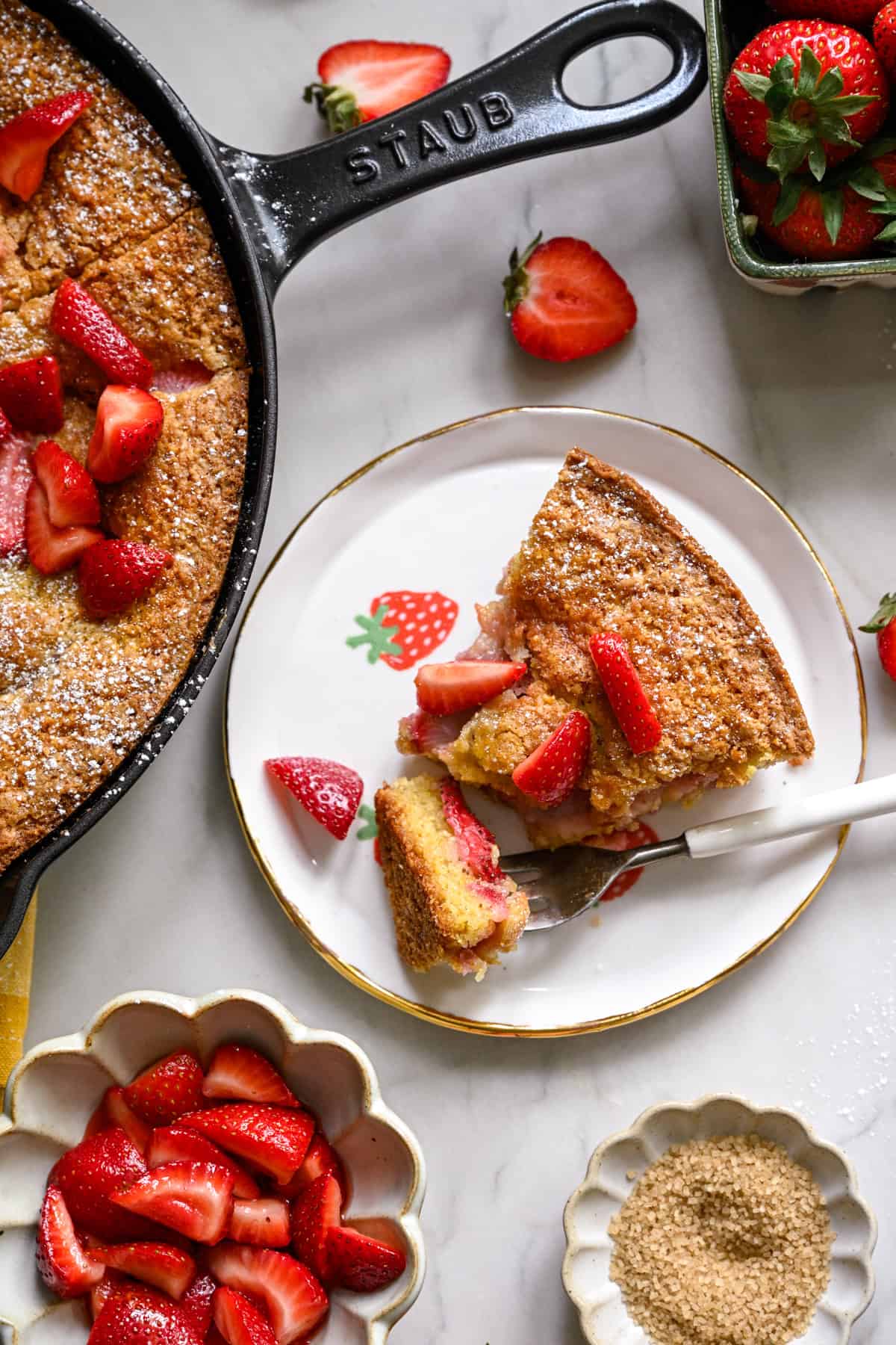 A slice of strawberry cornmeal cake on a white plate.