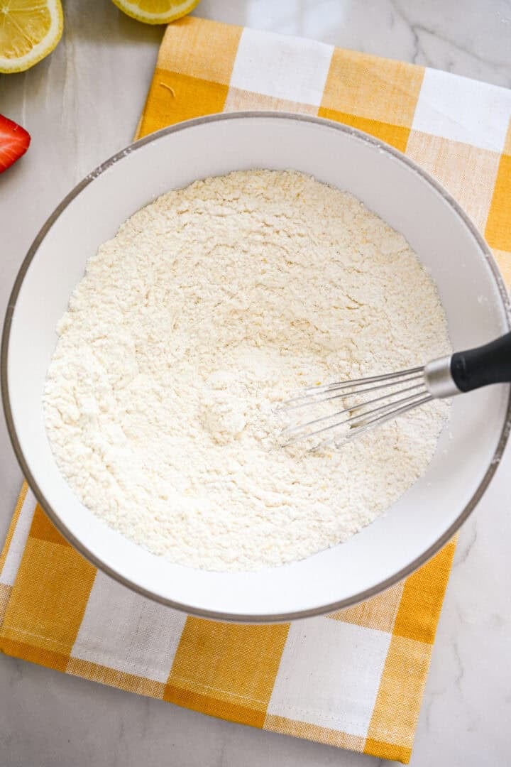 Dry ingredients mixed together in a white bowl for cake batter.