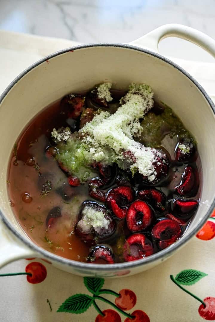 Overhead view of cherry limeade ingredients in a pot.