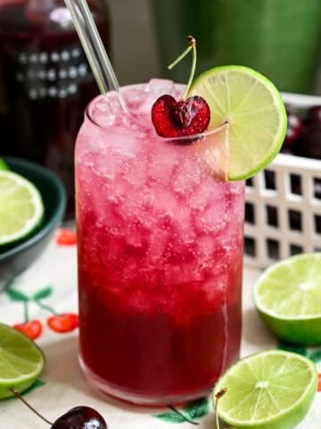 Front view of cherry lime soda in a glass.