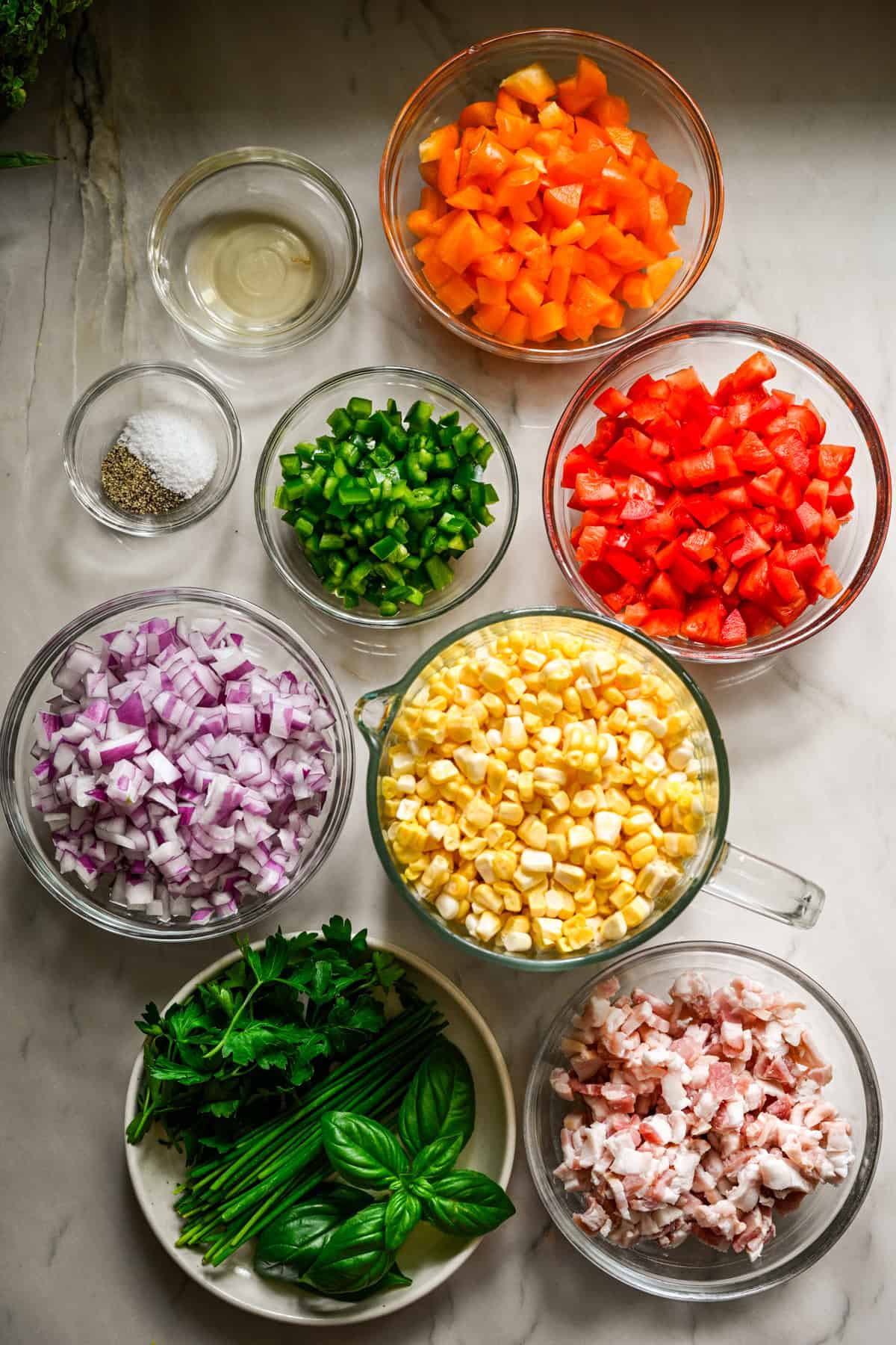 overhead view of ingredients for confetti corn in individual bowls.
