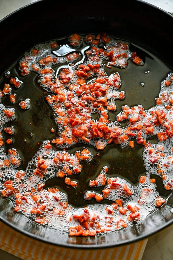 sautéed bacon in a skillet.