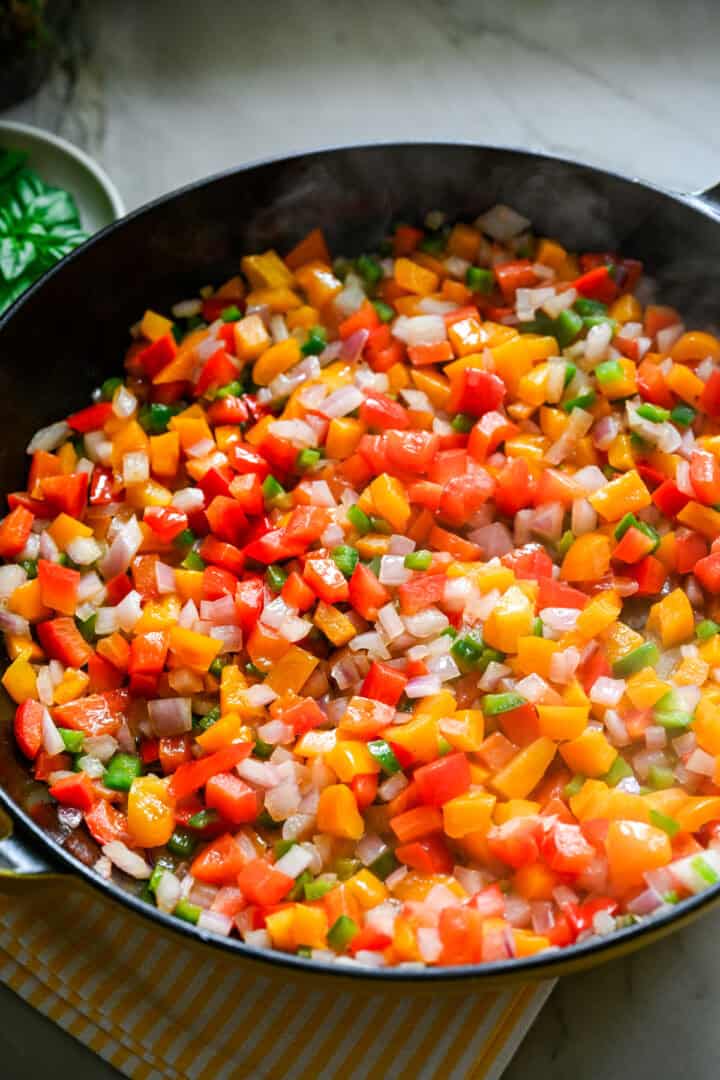 sautéed peppers and onion in a skillet.