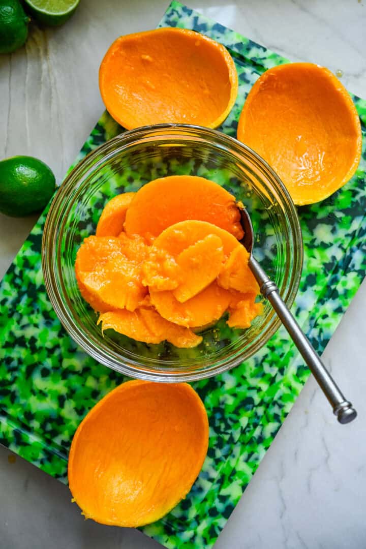 Overhead view of mango in a glass bowl.