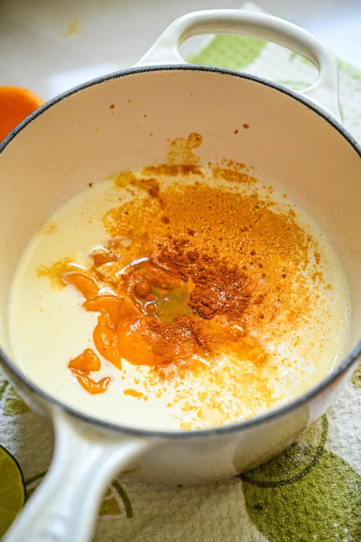 Mango posset ingredients in a saucepan.