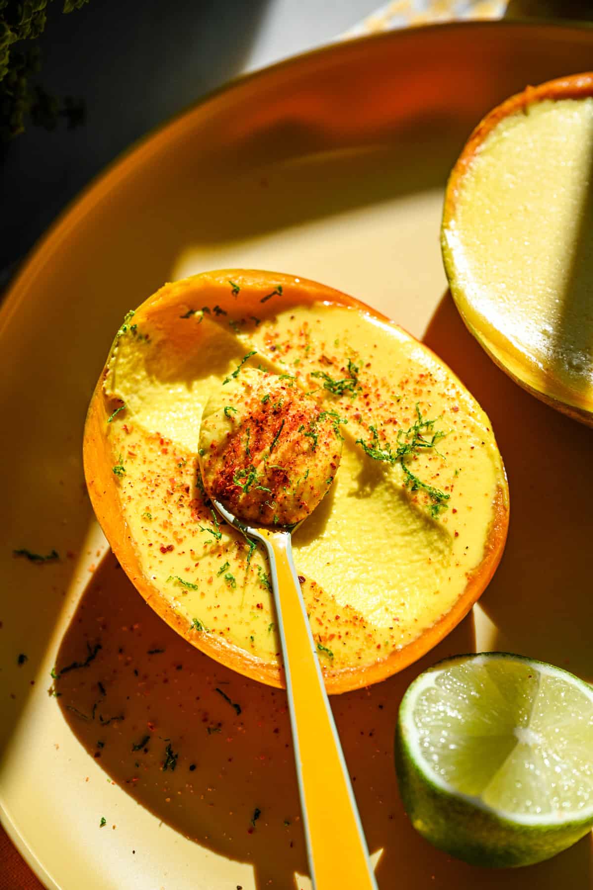 Overhead view of mango posset with tajin and lime zest.