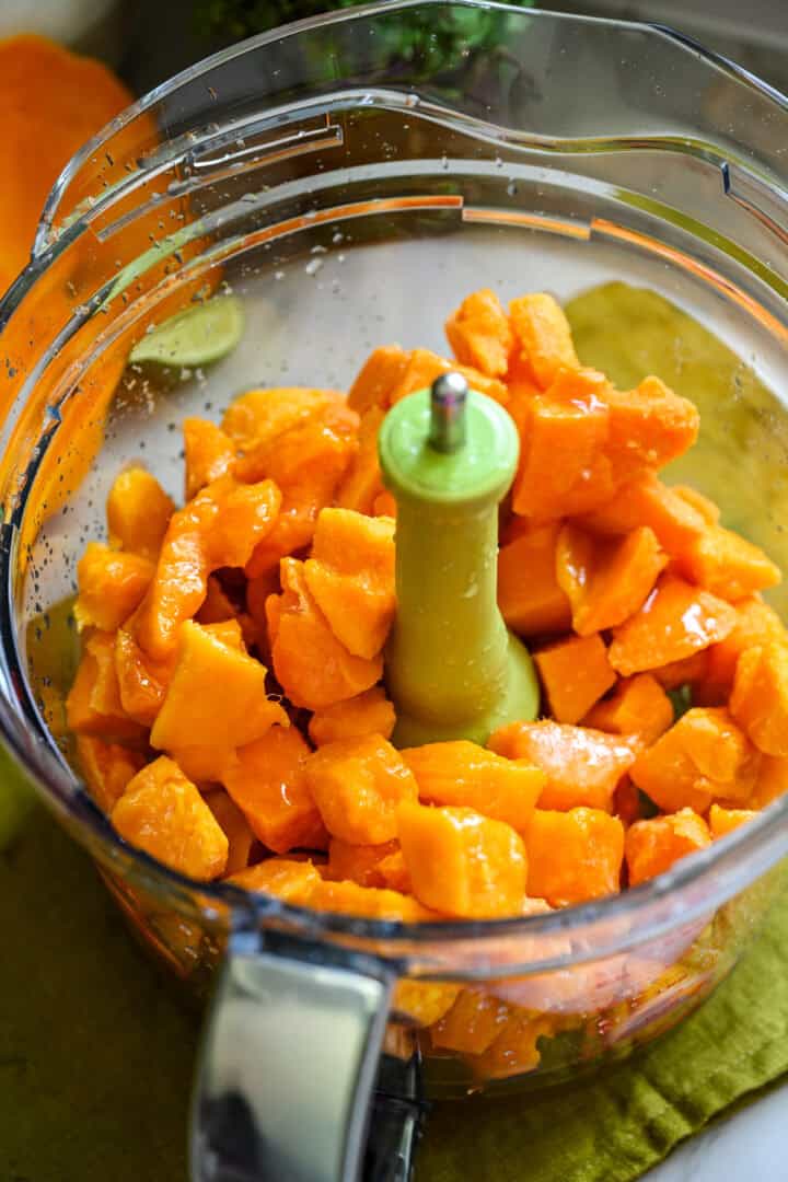 Mango sorbet ingredients in a food processor before blending.