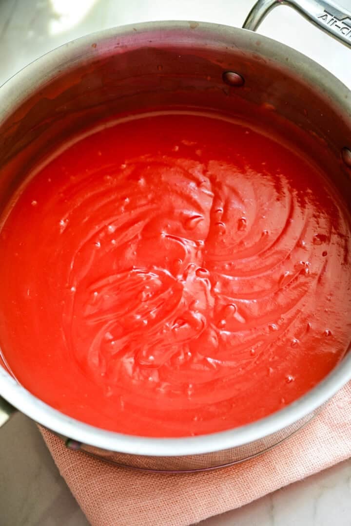 Overhead view of watermelon pudding in a steel saucepan.