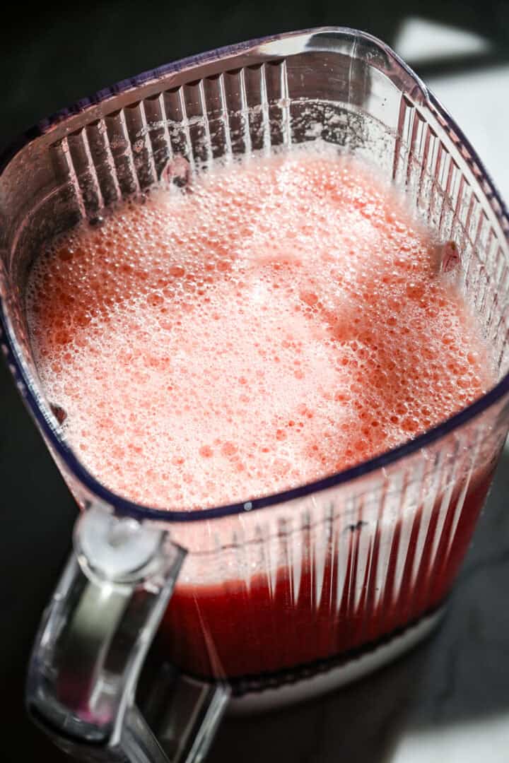 Overhead view of watermelon juice in a blender.