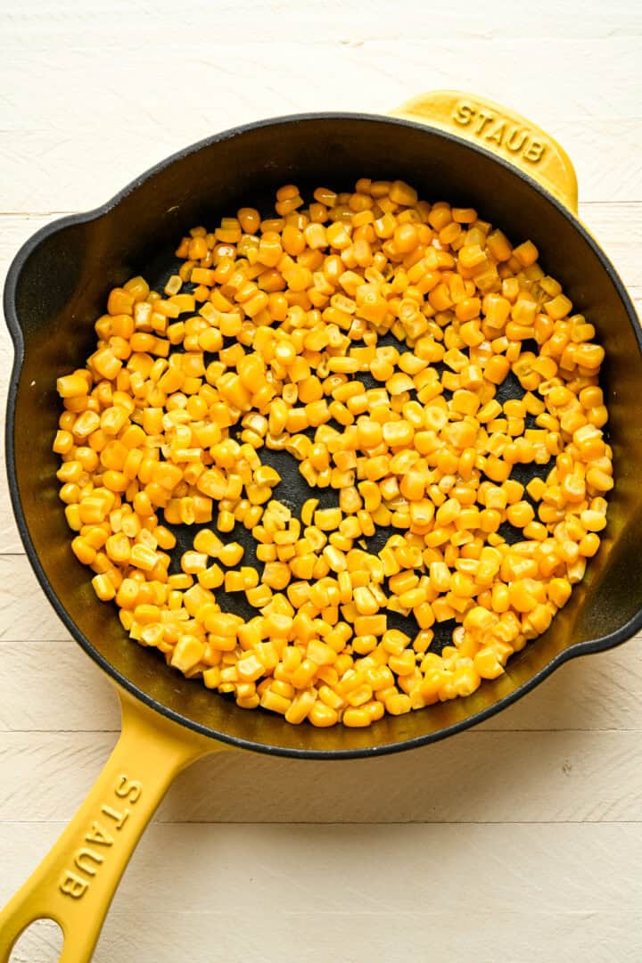 Sauteed corn in a skillet.