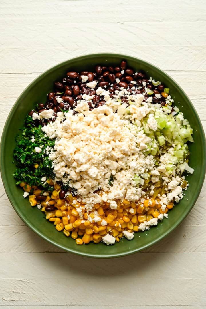 Black bean, corn and feta dip ingredients in a bowl before mixing together.