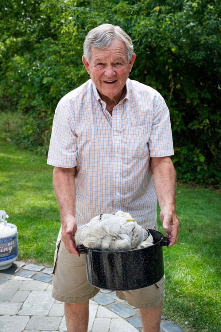 Grandpa holding a pot of clams.