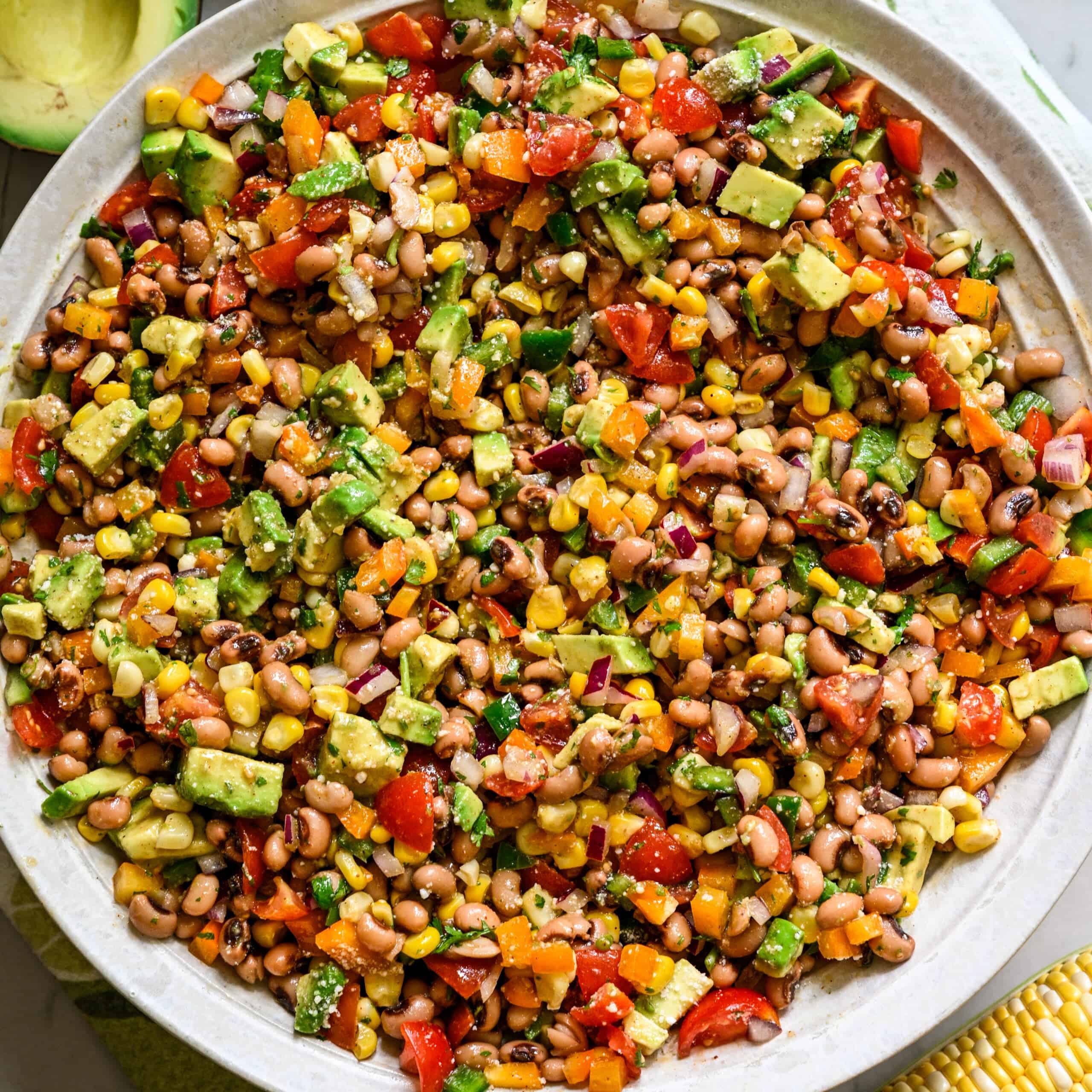 Overhead view of cowboy caviar salad in a big white salad bowl.