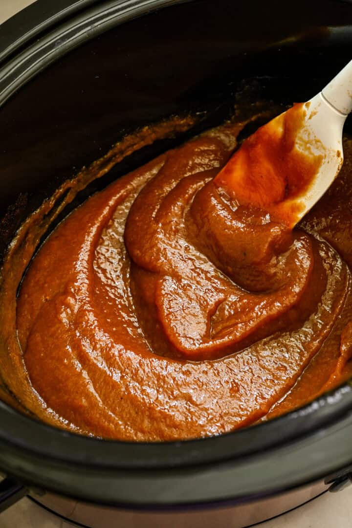 Finished peach butter in the slow cooker pot.