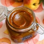 Peach butter in a swing top jar.