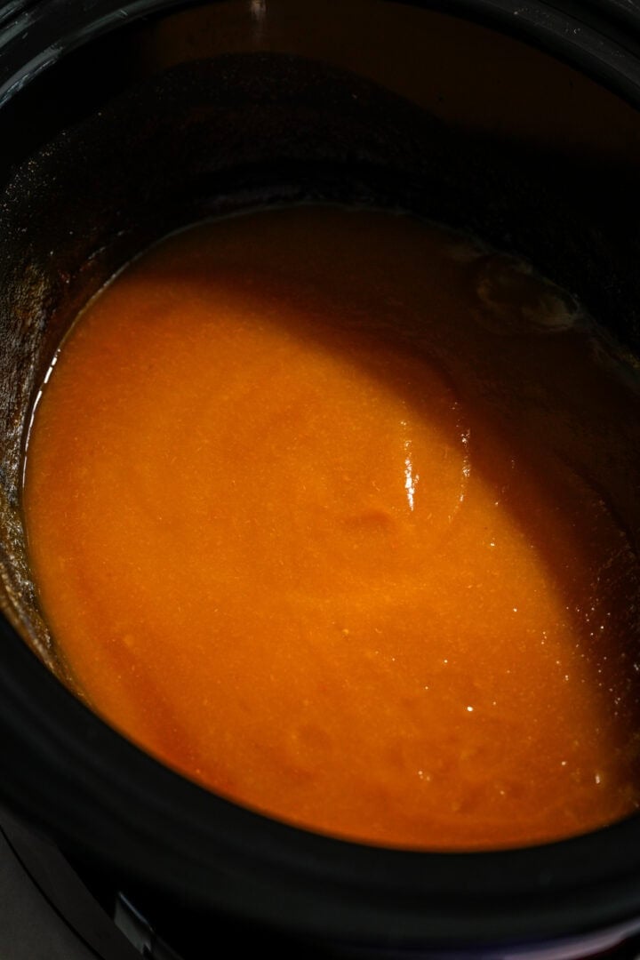 Peach butter after cooking for a while.