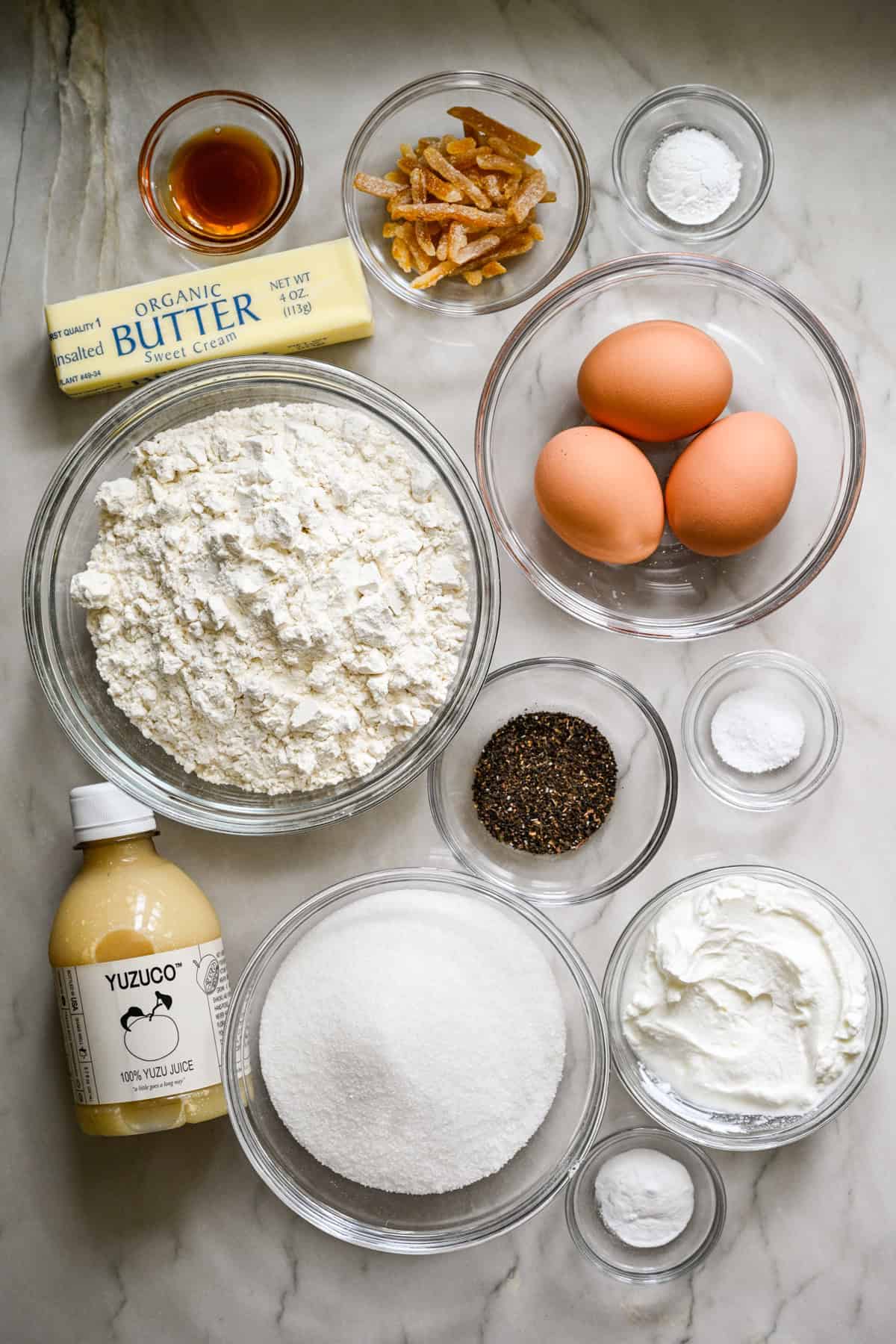 overhead view of ingredients for yuzu earl grey loaf cake in individual bowls.