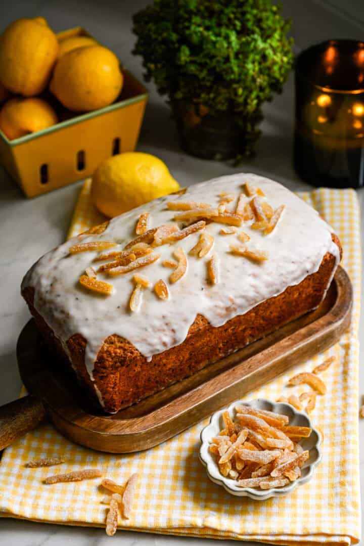 Whole earl grey yuzu loaf cake on a cutting board.