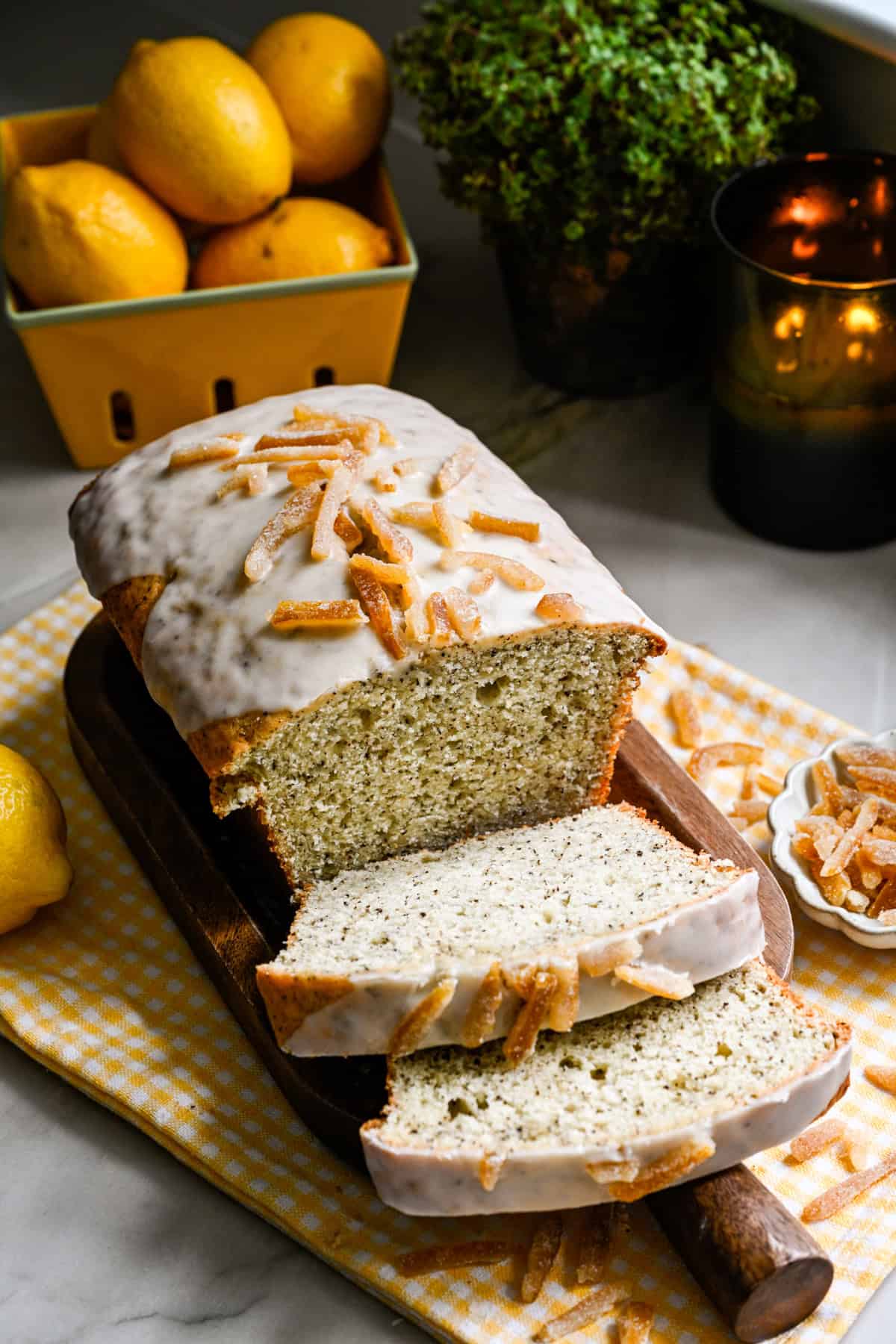 Yuzu earl grey loaf cake with a few slices sliced on cutting board.