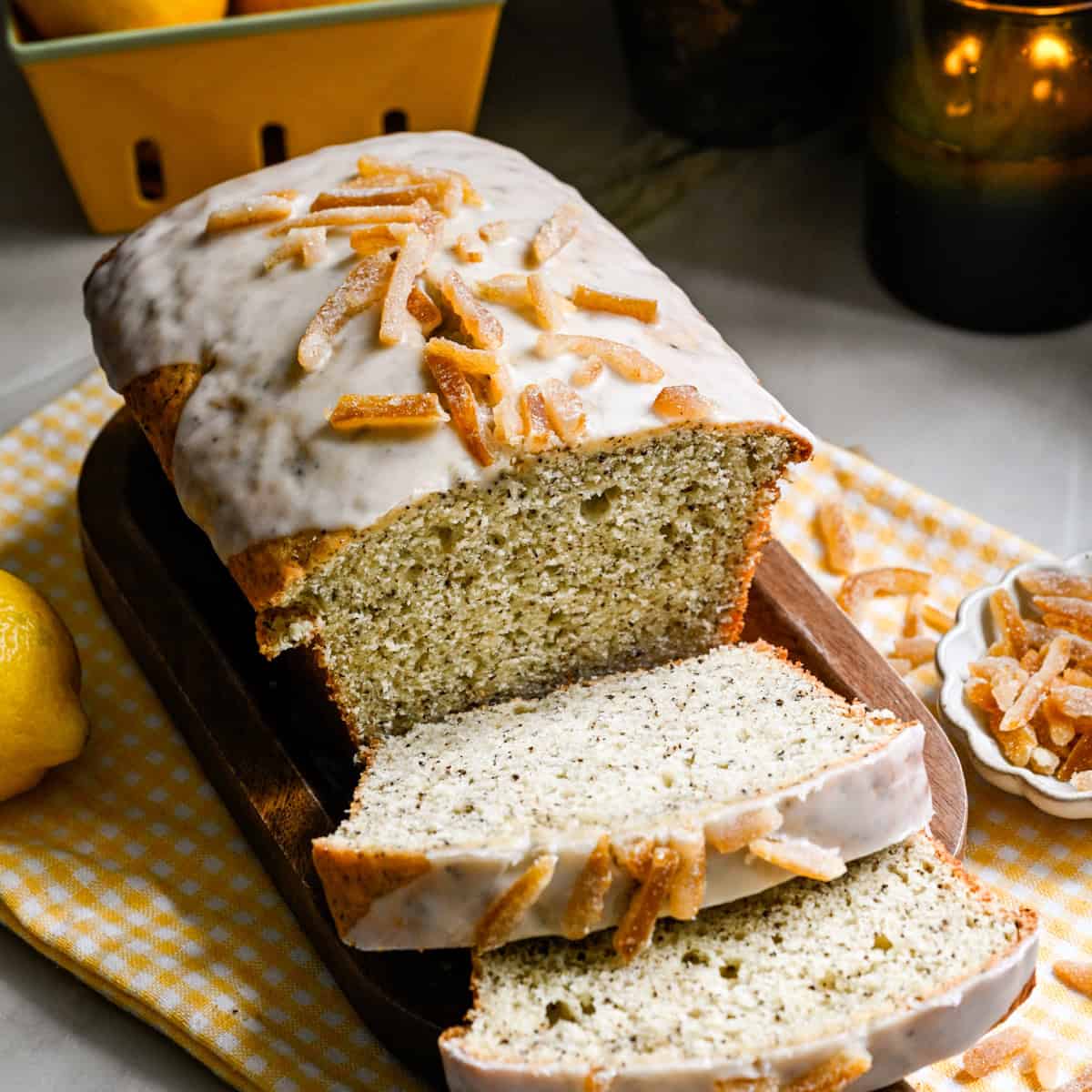 Yuzu earl grey loaf cake with a few slices sliced on cutting board.