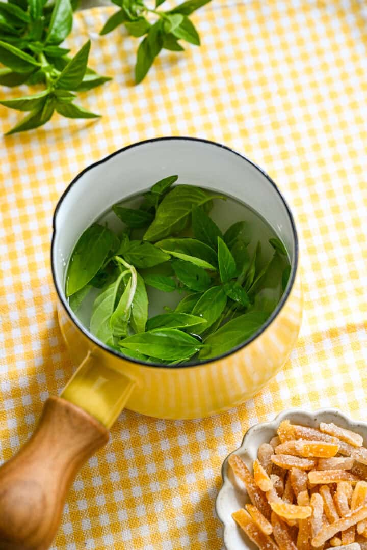basil simple syrup in small pot before cooking.