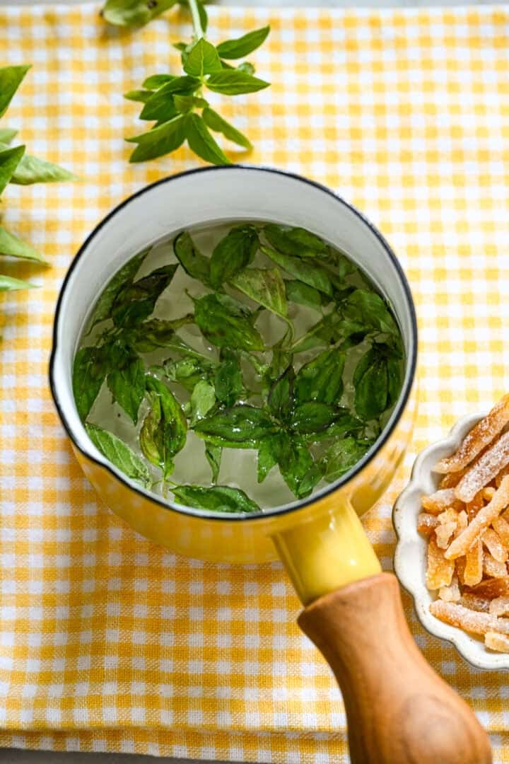 basil simple syrup in small pot after cooking.