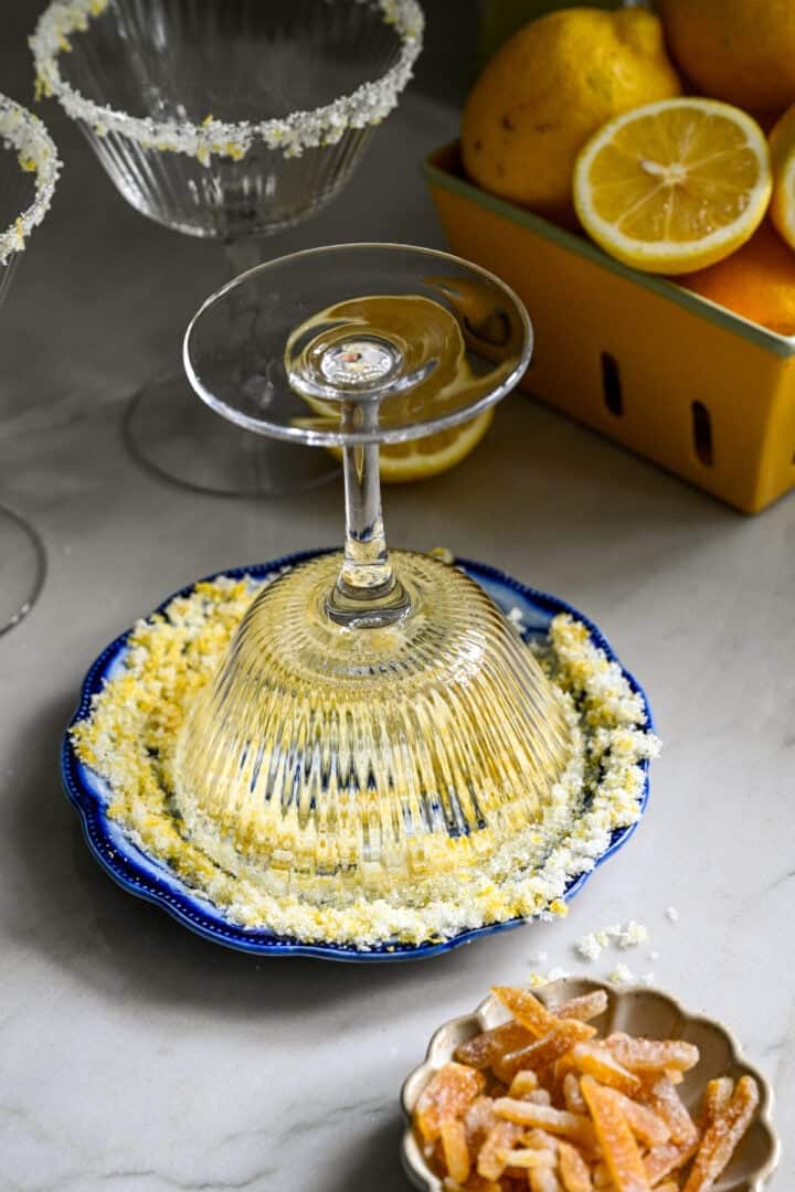 dipping cocktail glass rim in lemon sugar mixture.
