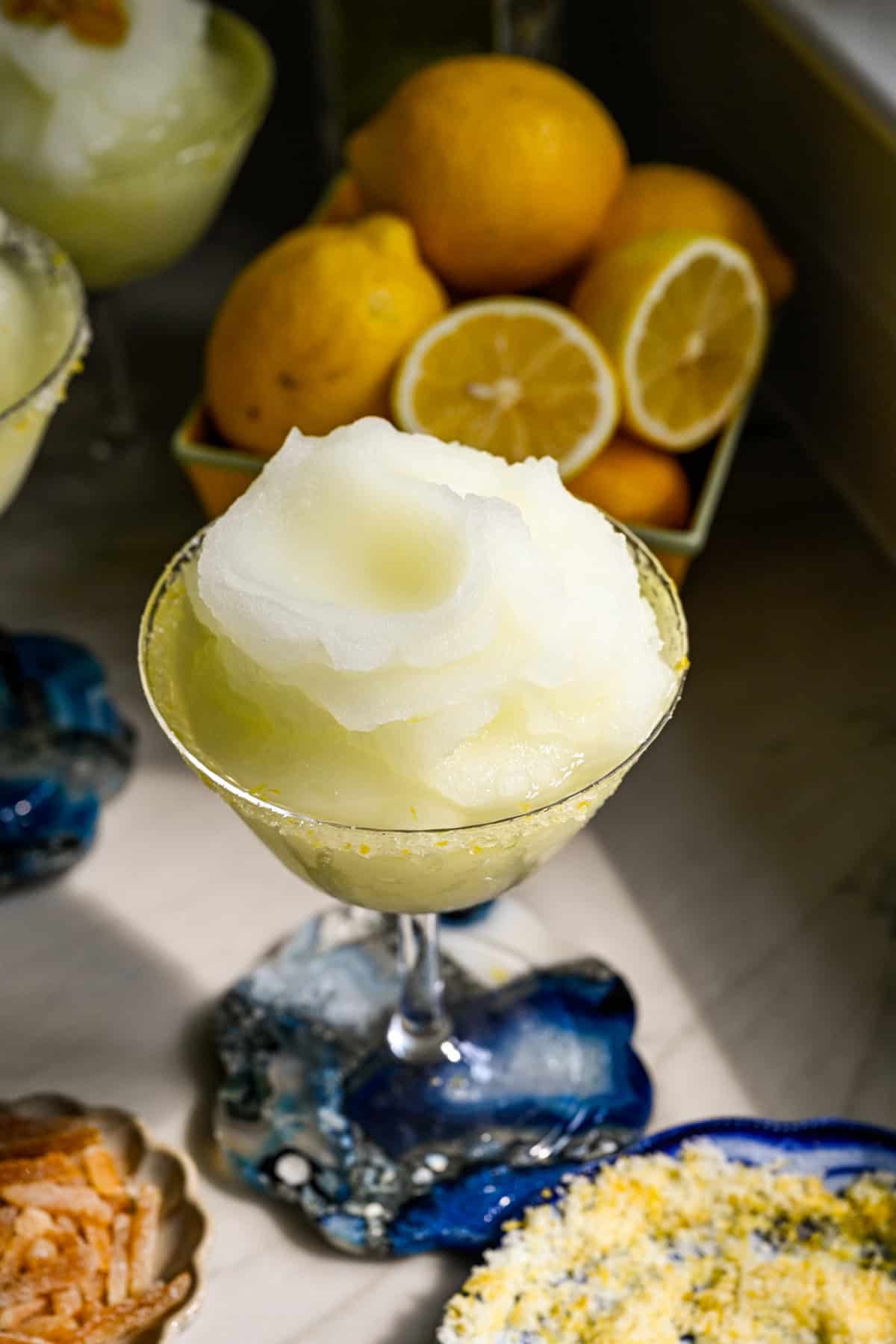 close up view of frozen limoncello cocktail in a coupe glass.
