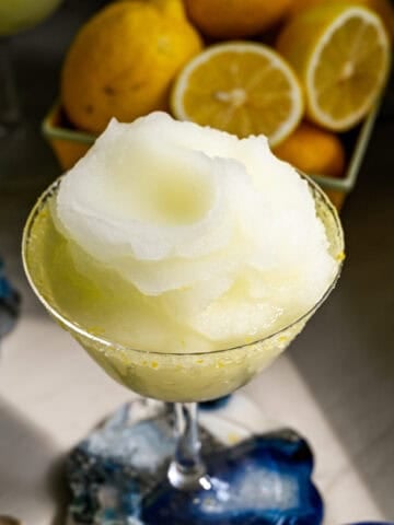 close up view of frozen limoncello cocktail in a coupe glass.