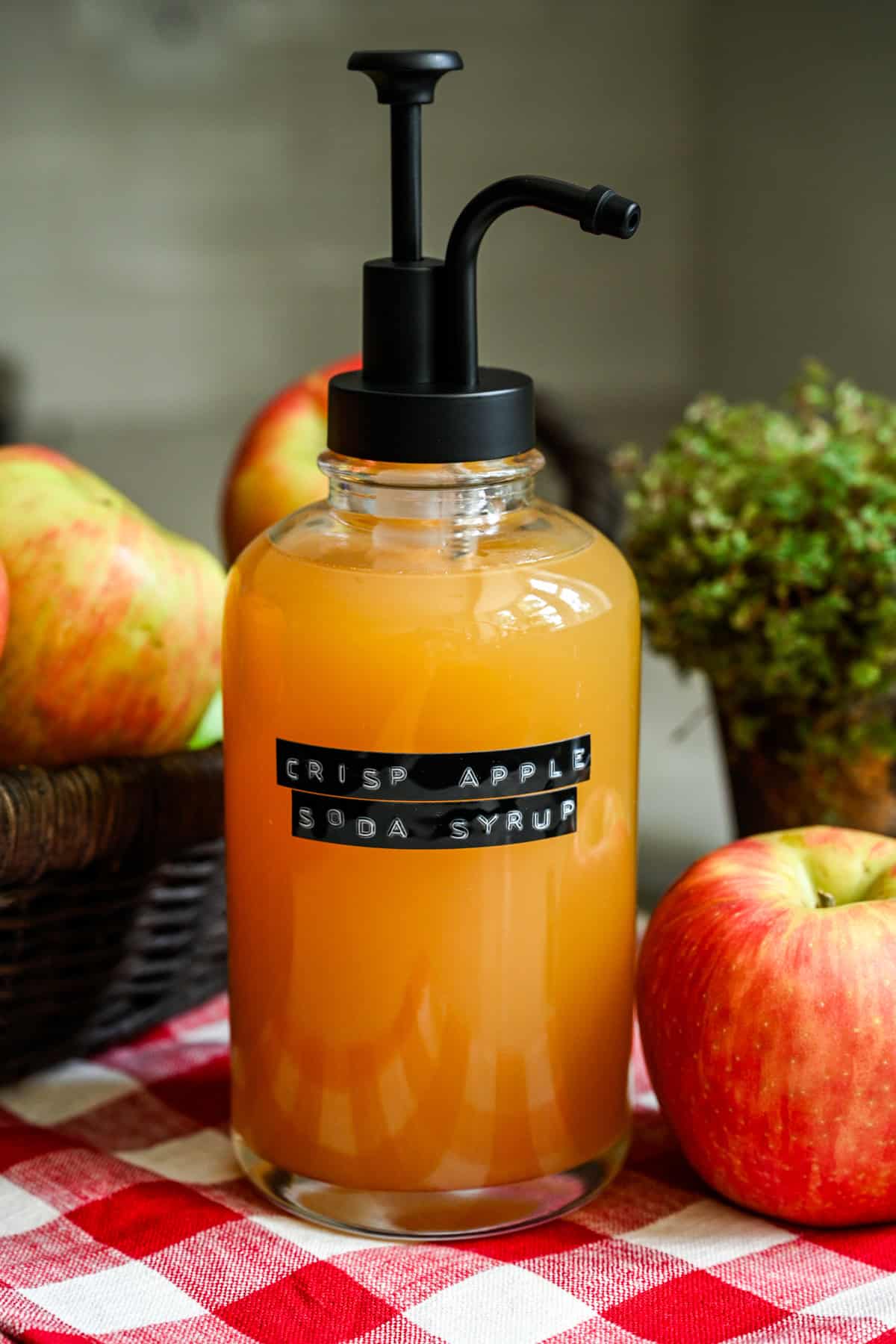 Homemade apple soda syrup in a pump bottle.