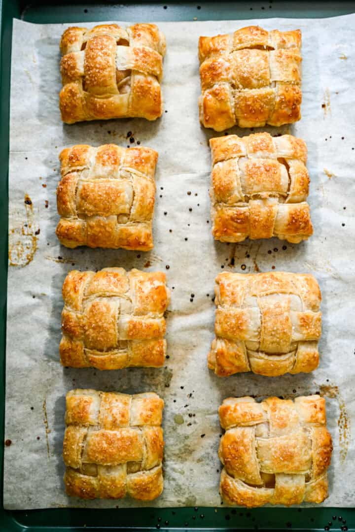 Overhead view of 8 hand pies on a parchment-lined sheet pan.