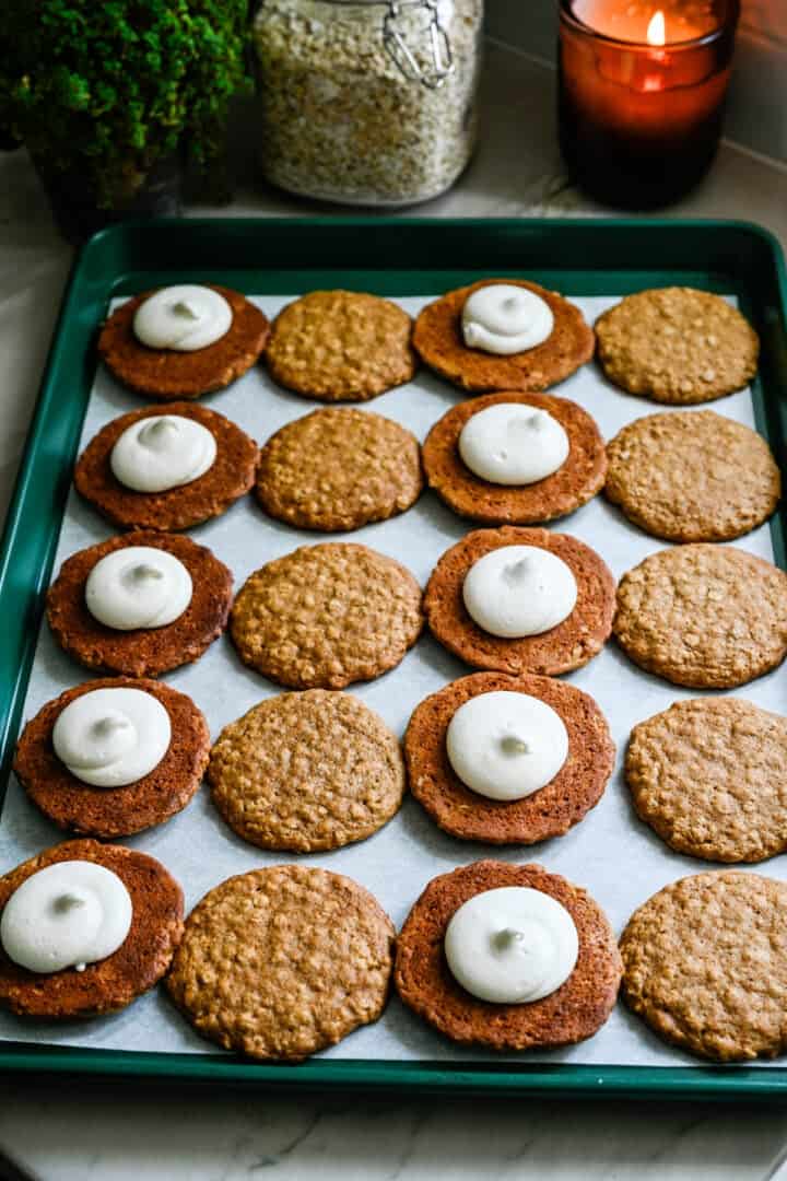 Overhead view of oatmeal cream pies on a sheet pan.