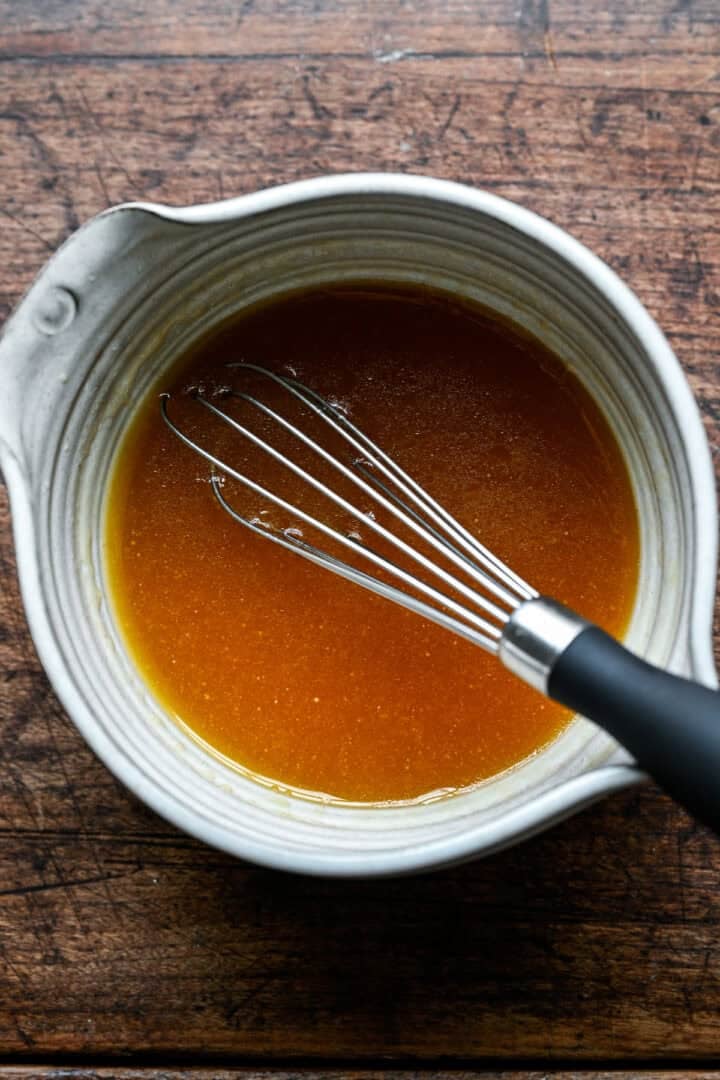 Melted butter, maple syrup, vanilla and bourbon whisked together in a small white pitcher.