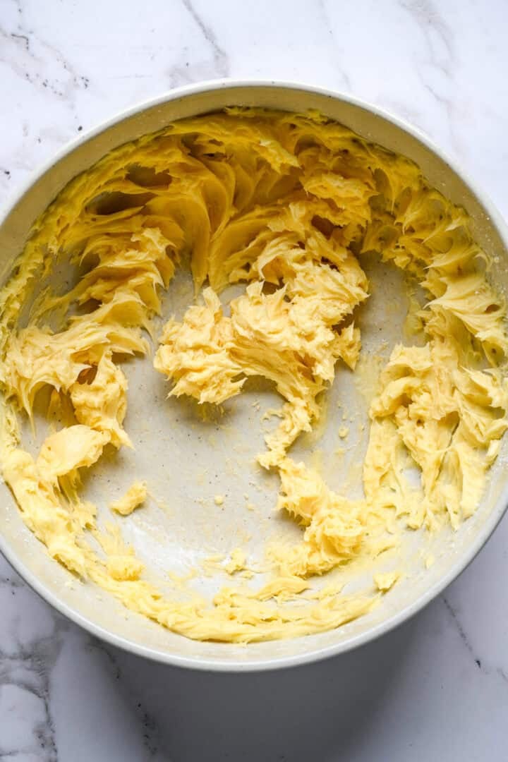Butter and powdered sugar beaten together in a bowl until smooth and pale yellow.