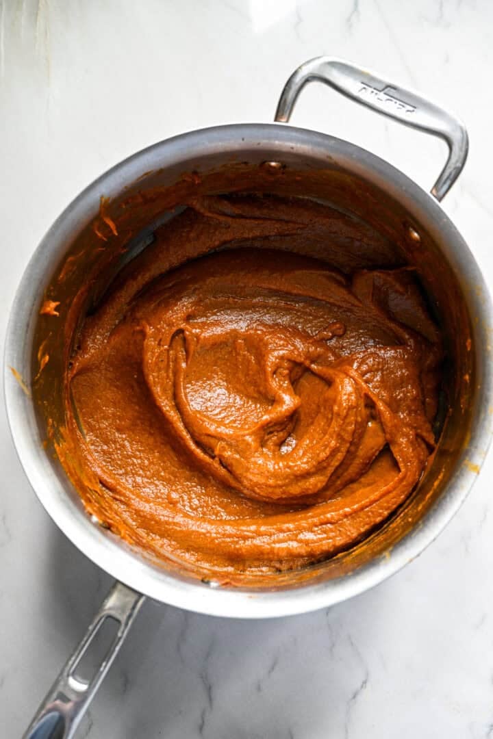 Homemade pumpkin butter in a saucepan after cooking it down into a thick paste.