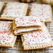 Close up view of homemade pumpkin pie pop tart cut in half to show filling and stacked on top of more pop tarts.
