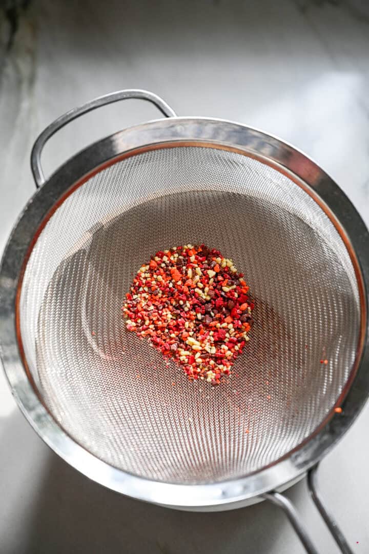 Crushed fall sprinkles in a sieve.