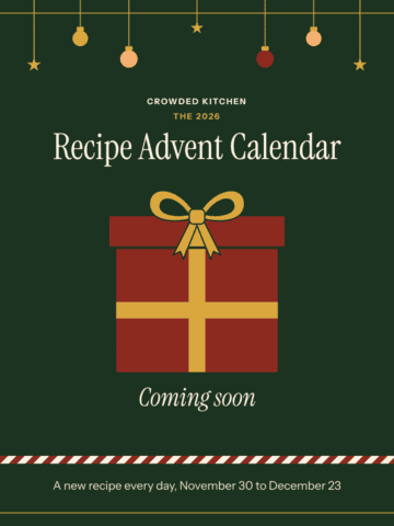 A wrapped red present with a gold bow, with text reading Crowded Kitchen 2026 Recipe Advent Calendar, coming soon, a new recipe every day from November 30 to December 23.